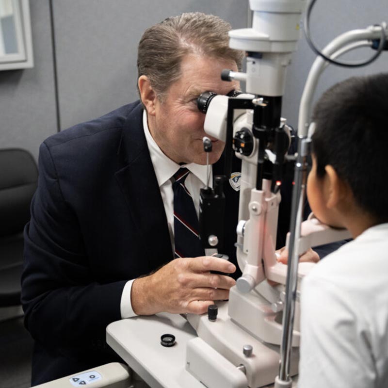 Dr. Court Wilkins performing an eye exam with a patient
