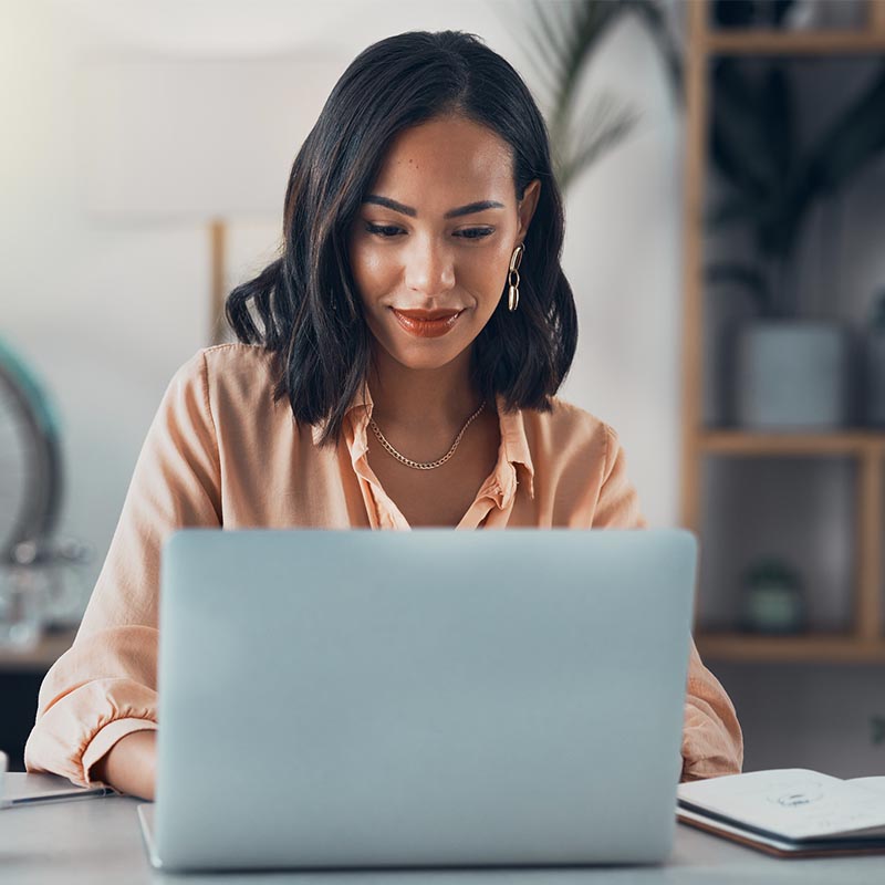 Woman working on laptop online, checking emails and planning on the internet while sitting in an office alone at work. Business woman, corporate professional or manager searching the internet photo People, Laptop, Using Computer, One Person, Computer